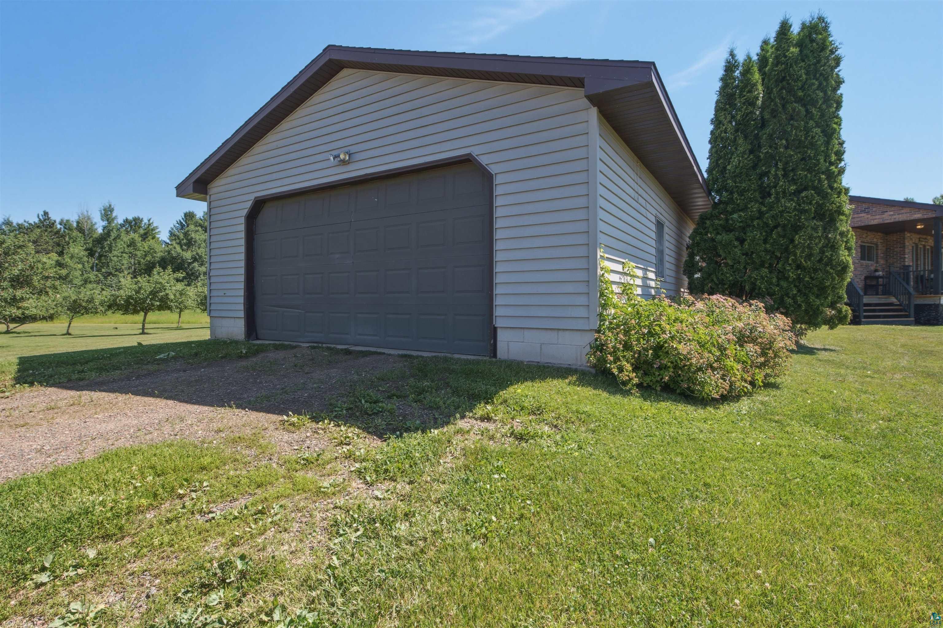 64260 Jolma Road Ashland, WI 54806 - Photo 25 of 35 Detached garage with horizontal siding and a dark panel garage door