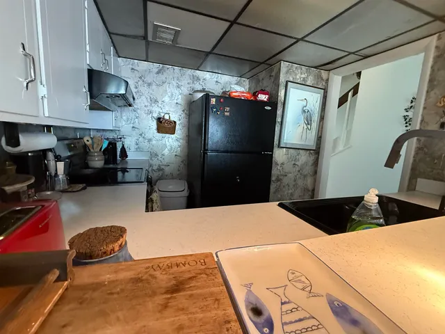 a kitchen with a refrigerator and cabinets