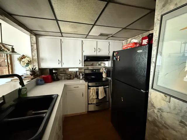 a kitchen with stainless steel appliances a refrigerator and a sink