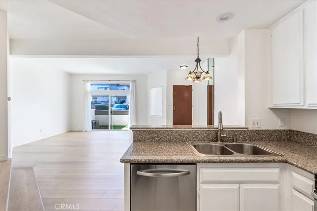 a view of a kitchen with granite countertop a sink and a stove