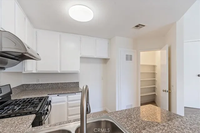 a kitchen with a stove and a refrigerator