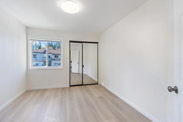 an empty room with windows and closet