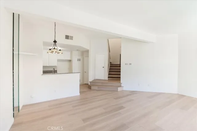 a view of a kitchen with wooden cabinets and a ceiling fan