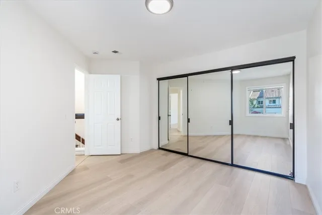 an empty room with windows and closet