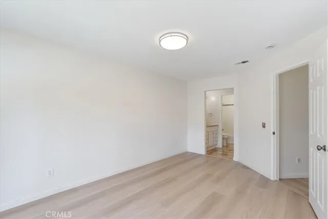 a bathroom with a tub shower sink vanity granite and toilet