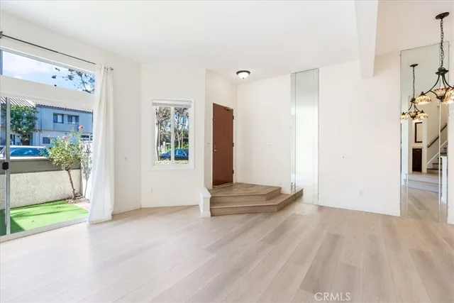 a view of an entryway with wooden floor