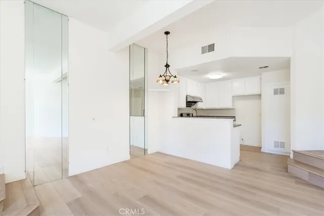 a view of a kitchen with wooden floor