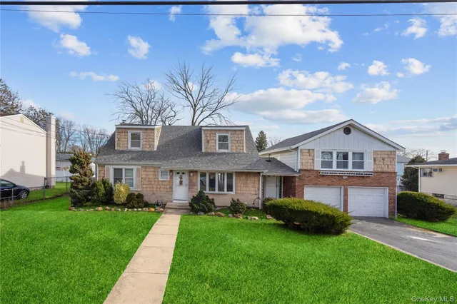 a front view of a house with a garden and yard