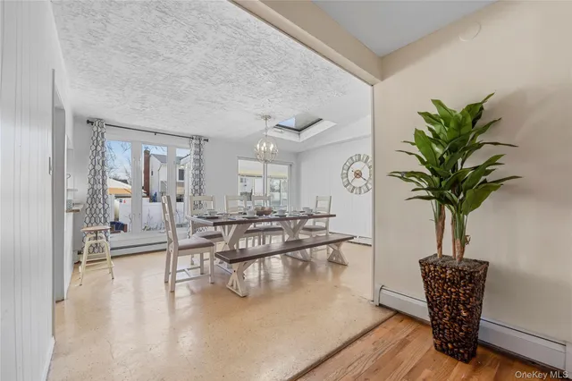 a living room with furniture potted plant and a table