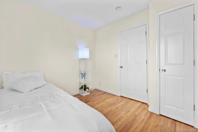 a bedroom with a bed and a night stand