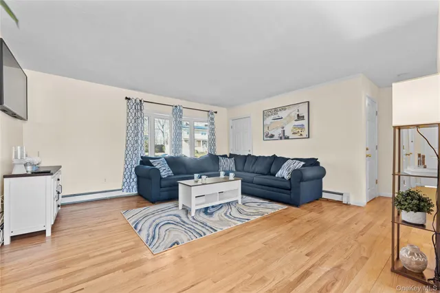 a living room with furniture window and wooden floor