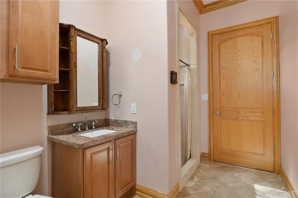 a bathroom with a granite countertop sink and a mirror