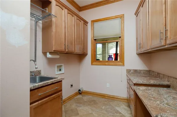 a kitchen with granite countertop cabinets stainless steel appliances and a counter