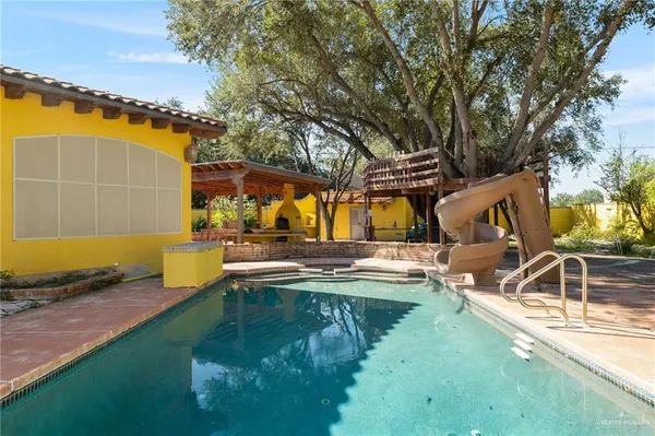 swimming pool view with a outdoor seating