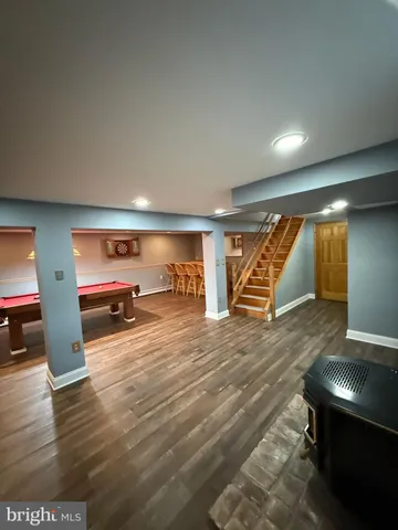 a view of a room wooden floor and windows