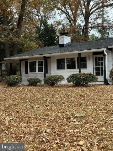 front view of house with a tree