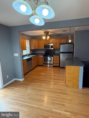 a view of kitchen and dining room with wooden floor