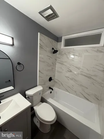 a bathroom with a toilet a sink and bathtub