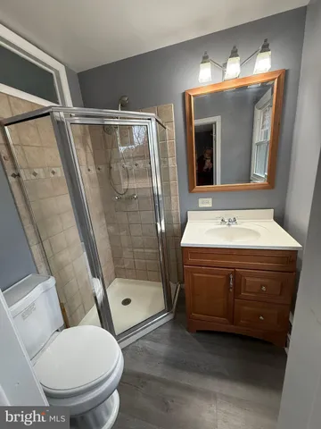 a bathroom with a double vanity sink toilet and shower