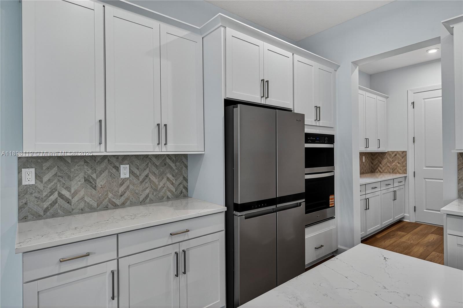 2722 Northwest 87th Terrace Cooper City, FL 33024 - Photo 14 of 44 a kitchen with cabinets and stainless steel appliances