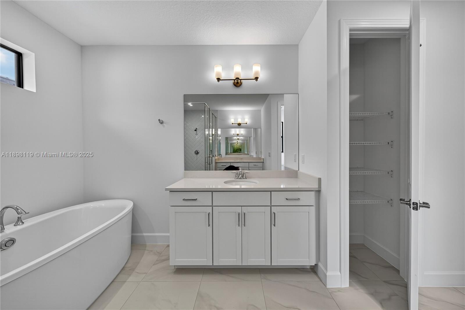 2722 Northwest 87th Terrace Cooper City, FL 33024 - Photo 19 of 44 a bathroom with a granite countertop bathtub a sink and a mirror