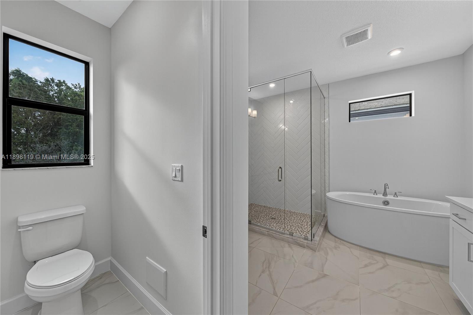 2722 Northwest 87th Terrace Cooper City, FL 33024 - Photo 20 of 44 a white toilet sitting next to a bathroom sink and tub