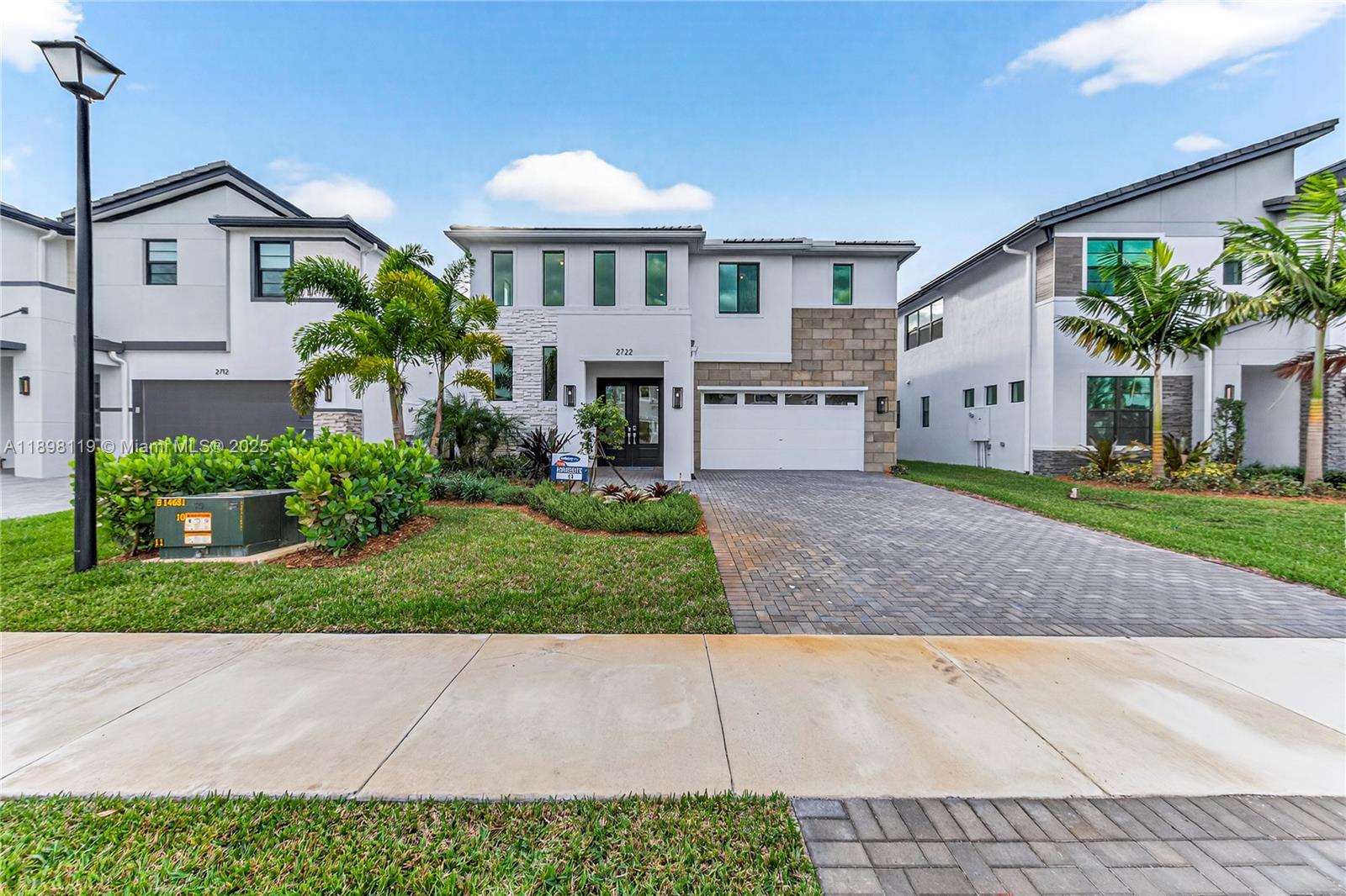 2722 Northwest 87th Terrace Cooper City, FL 33024 - Photo 2 of 44 a front view of a house with a yard and potted plants