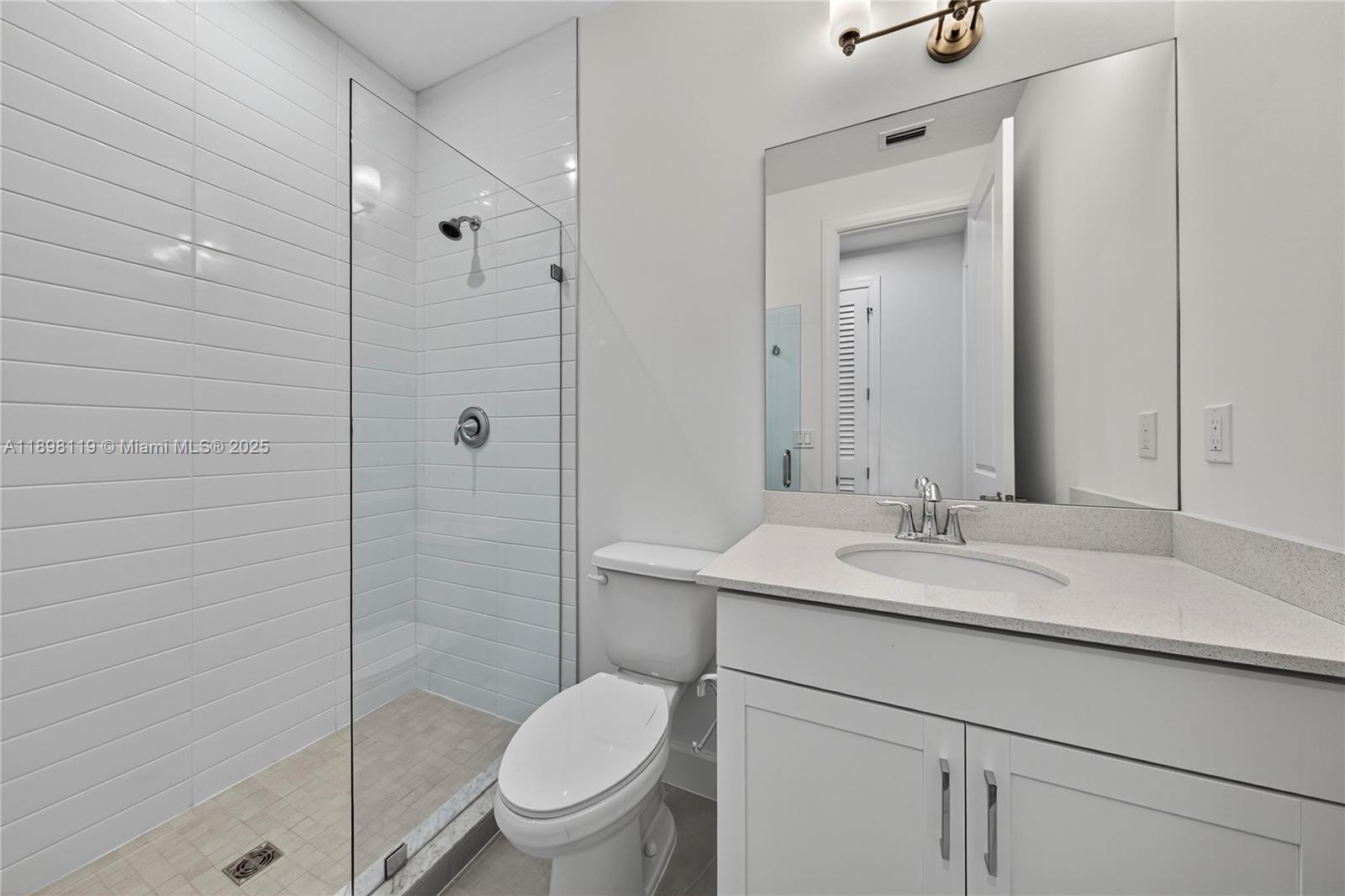 2722 Northwest 87th Terrace Cooper City, FL 33024 - Photo 23 of 44 a bathroom with a granite countertop sink toilet a mirror and shower