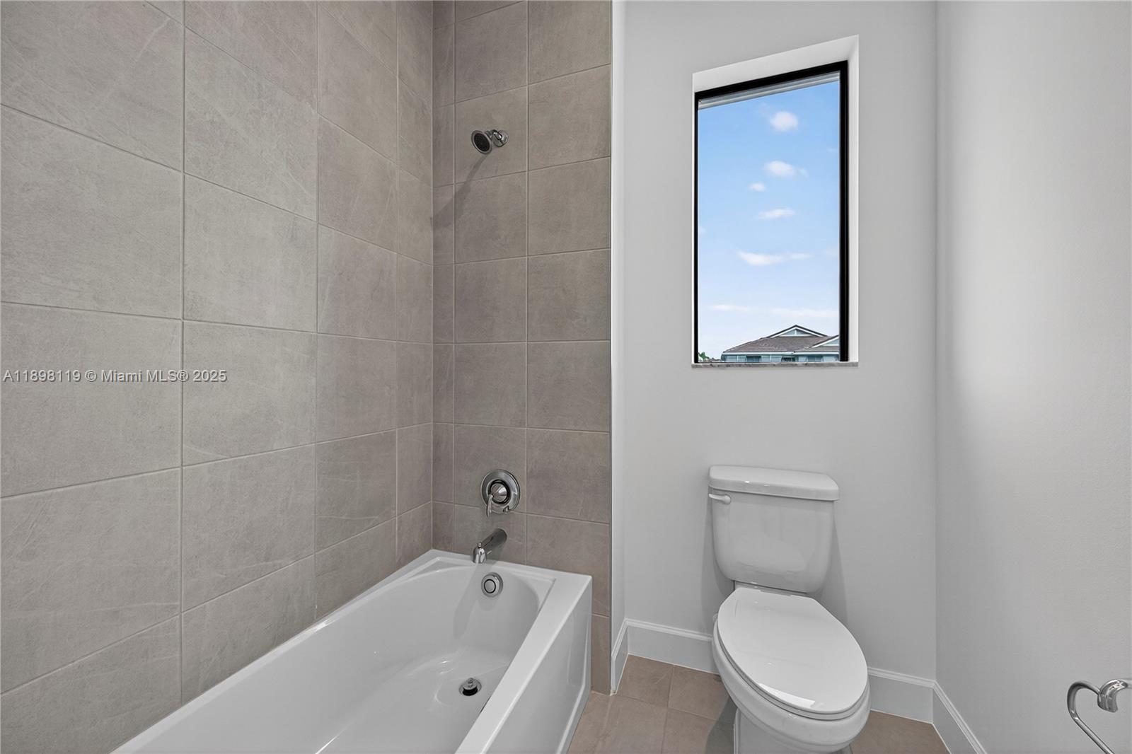 2722 Northwest 87th Terrace Cooper City, FL 33024 - Photo 27 of 44 a white toilet sitting next to a bathtub