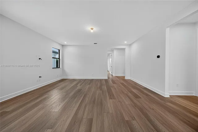 a view of an empty room and wooden floor
