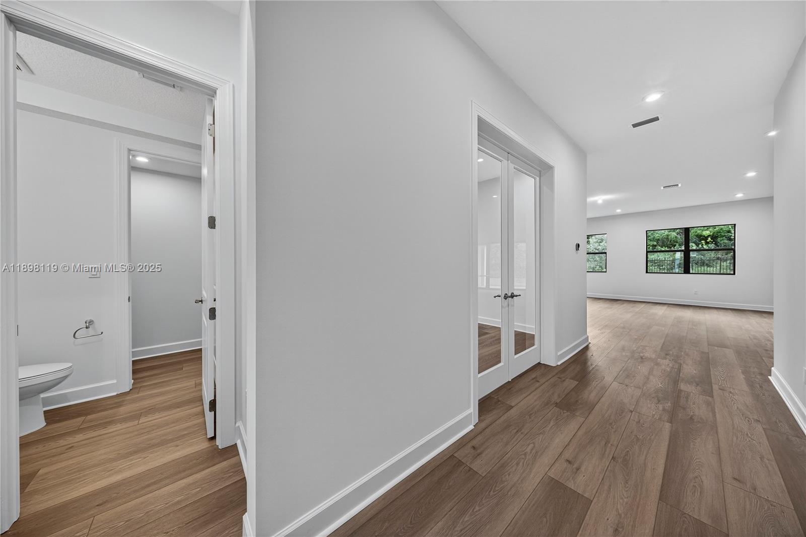 2722 Northwest 87th Terrace Cooper City, FL 33024 - Photo 33 of 44 a view of a hallway with wooden floor and a bathroom