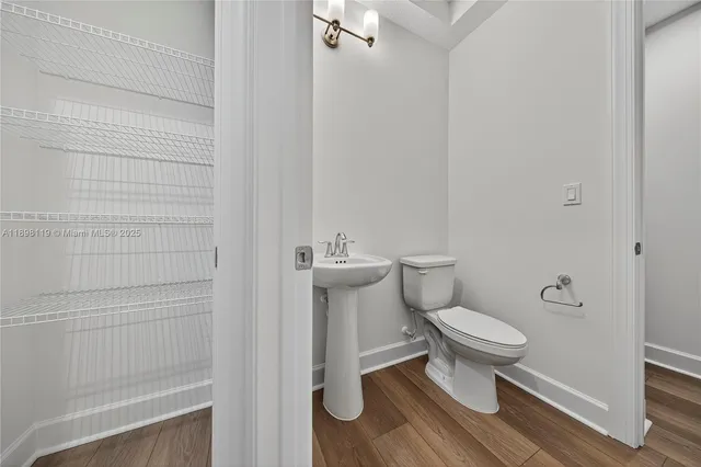 a white toilet sitting next to a shower