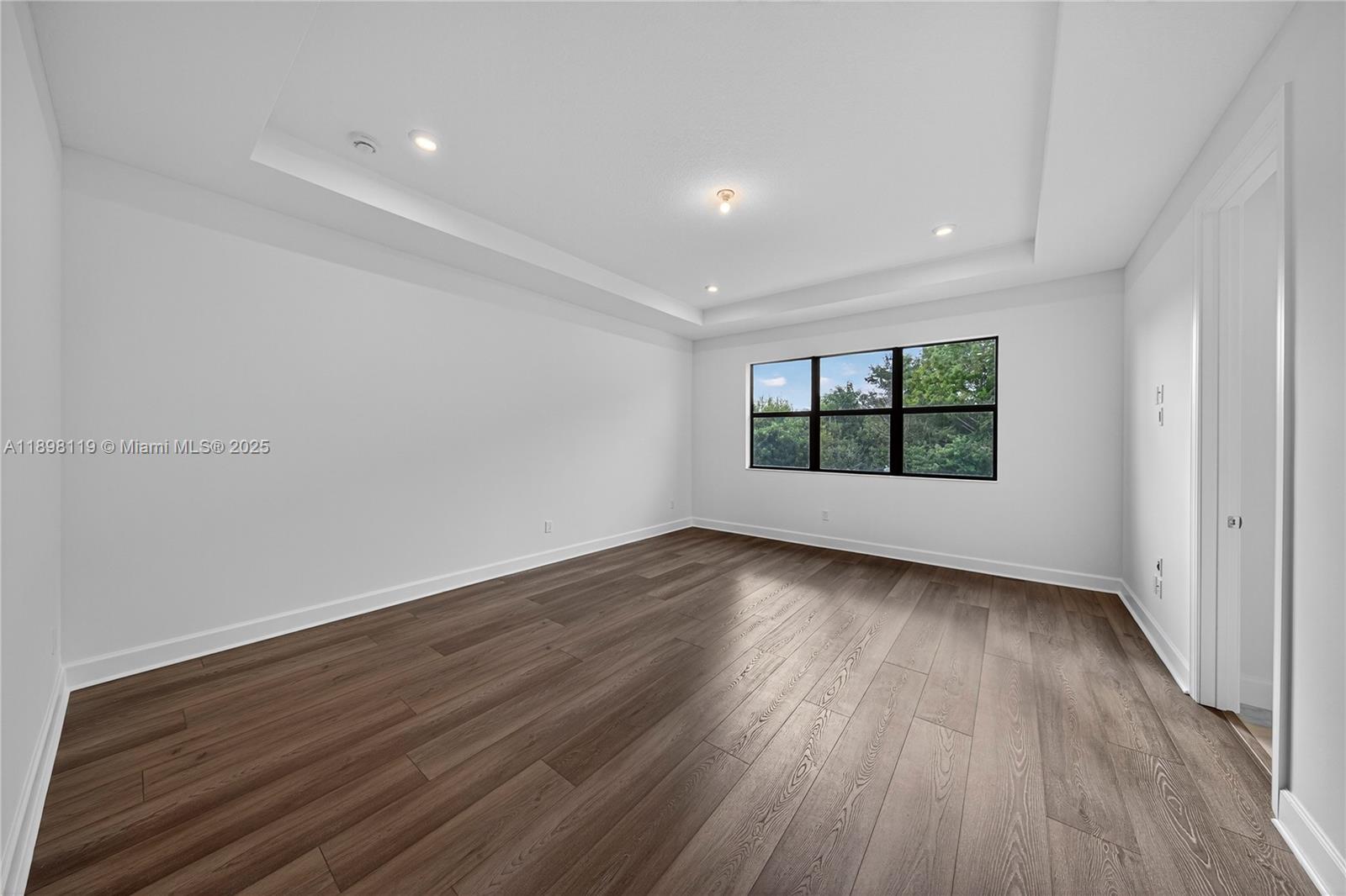 2722 Northwest 87th Terrace Cooper City, FL 33024 - Photo 6 of 44 wooden floor in an empty room with a window