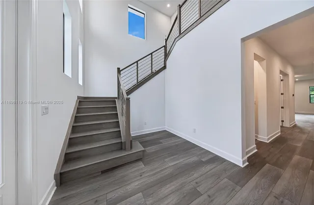 a view of entryway and hall with wooden floor