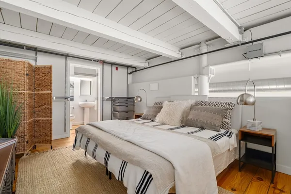 a bedroom with a bed and a table