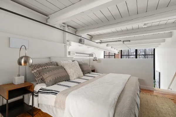 a bedroom with bed and a window