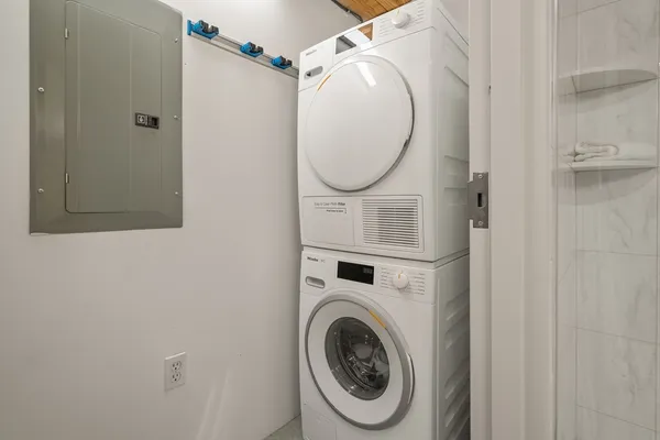 a close view of a utility room with dryer and washer