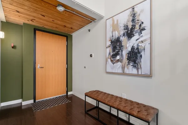 a view of a hallway with wooden floor and a window