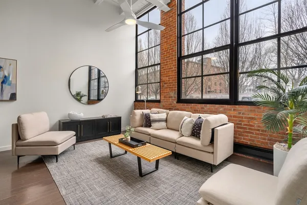 a living room with furniture and a large window