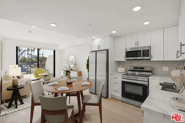 a kitchen with a dining table and chairs
