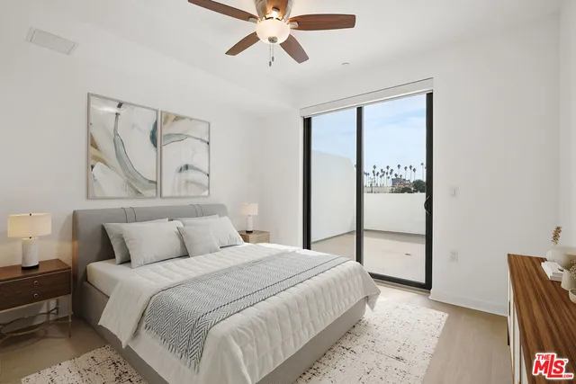 a bedroom with a bed and a painting on the wall