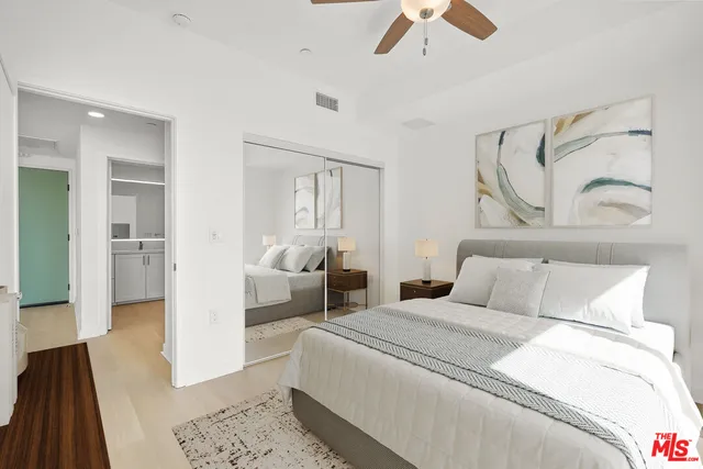 a bedroom with a bed and a couch