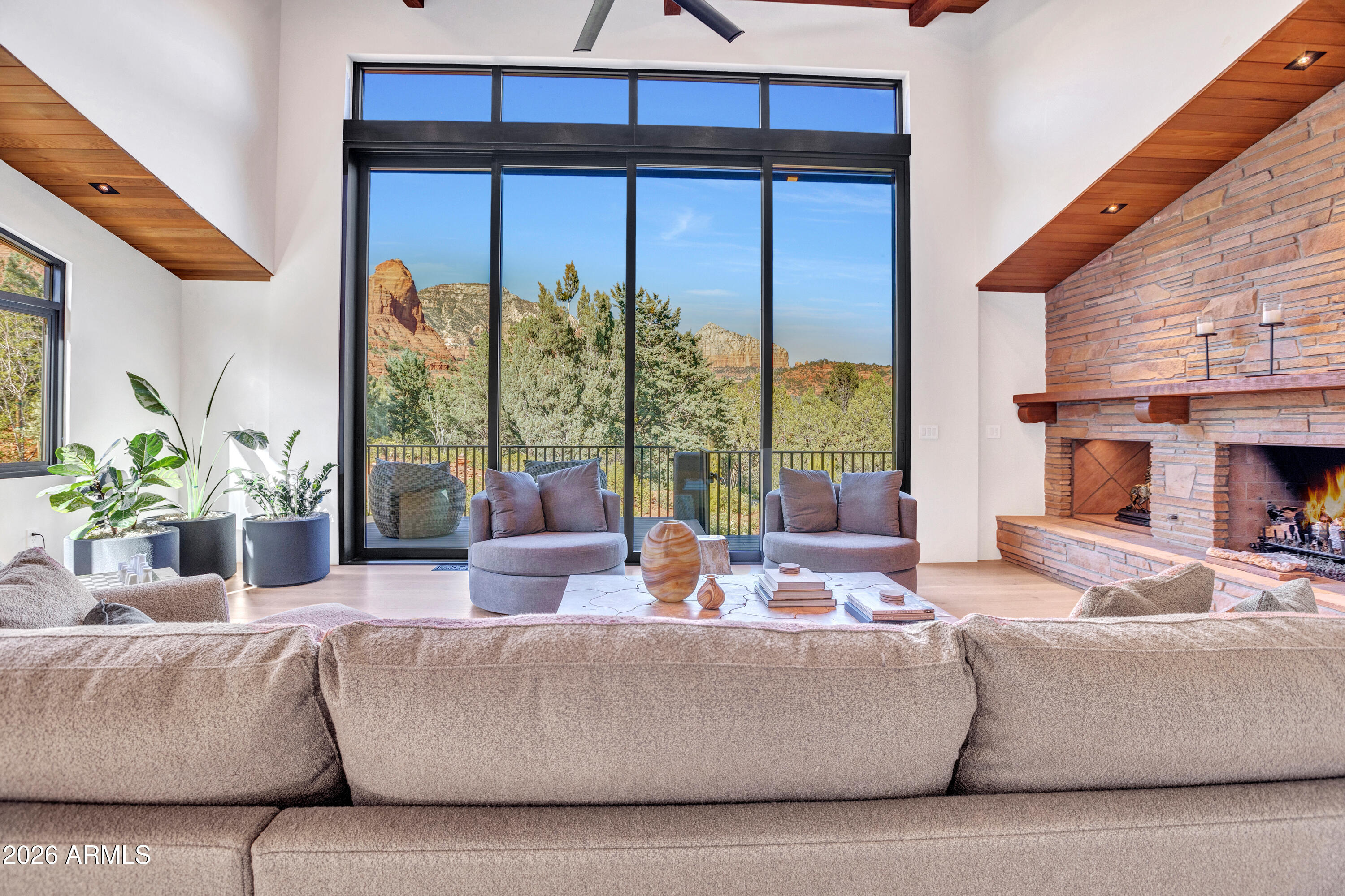 180 Rim Shadows Drive Sedona, AZ 86336 - Photo 13 of 72 a living room with furniture and a large window