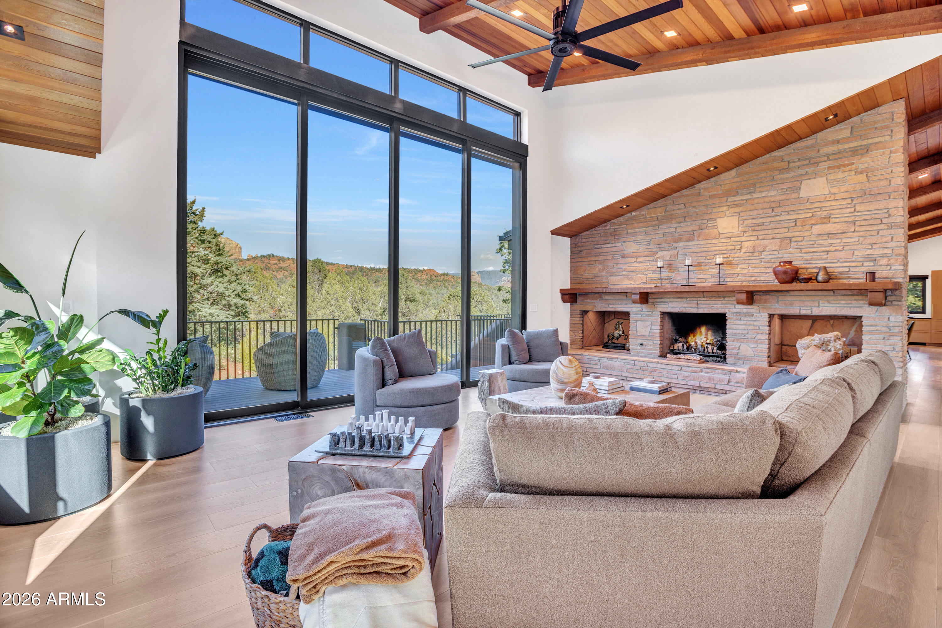 180 Rim Shadows Drive Sedona, AZ 86336 - Photo 14 of 72 a living room with furniture fireplace and large windows