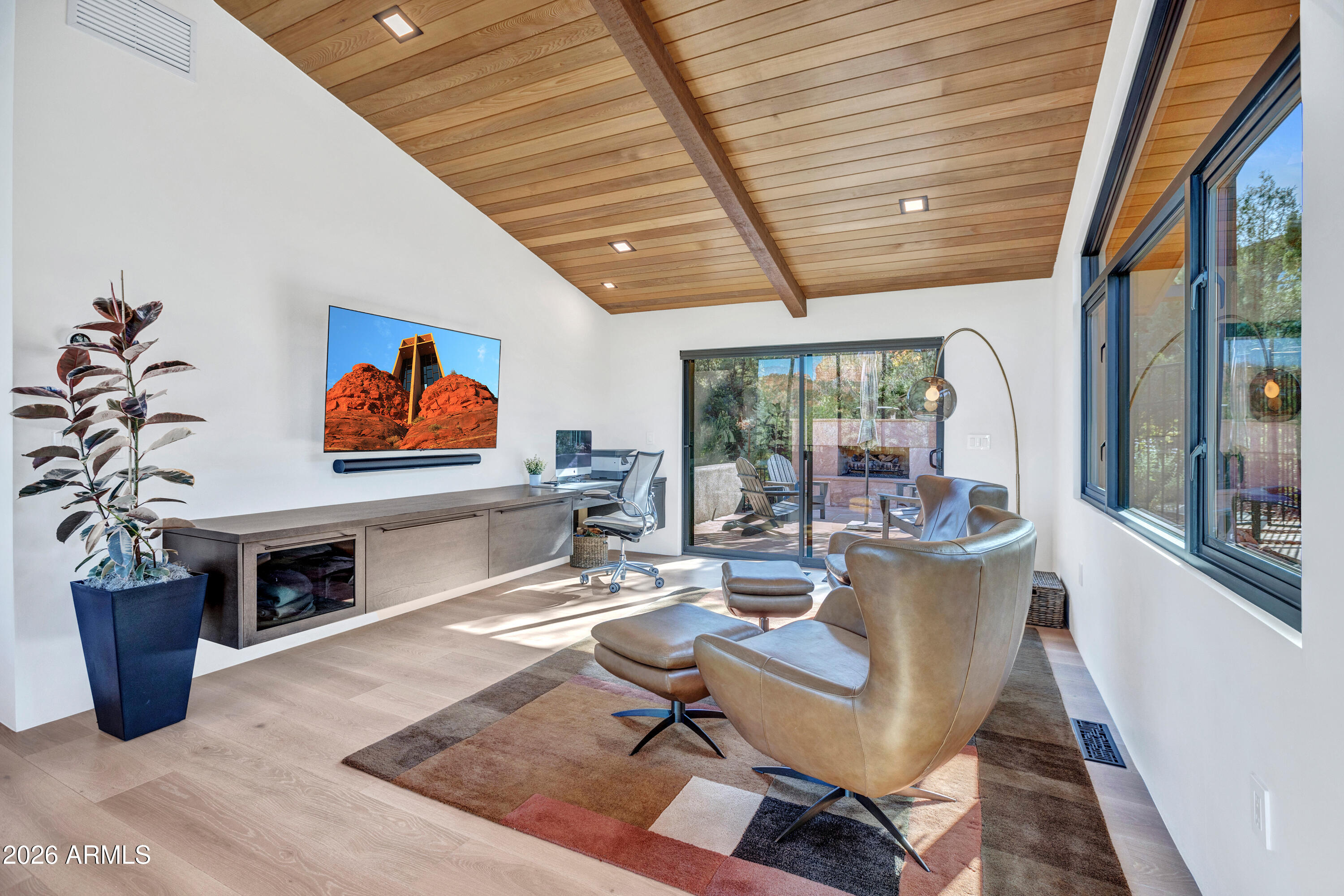 180 Rim Shadows Drive Sedona, AZ 86336 - Photo 16 of 72 a living room with furniture a flat screen tv and a floor to ceiling window