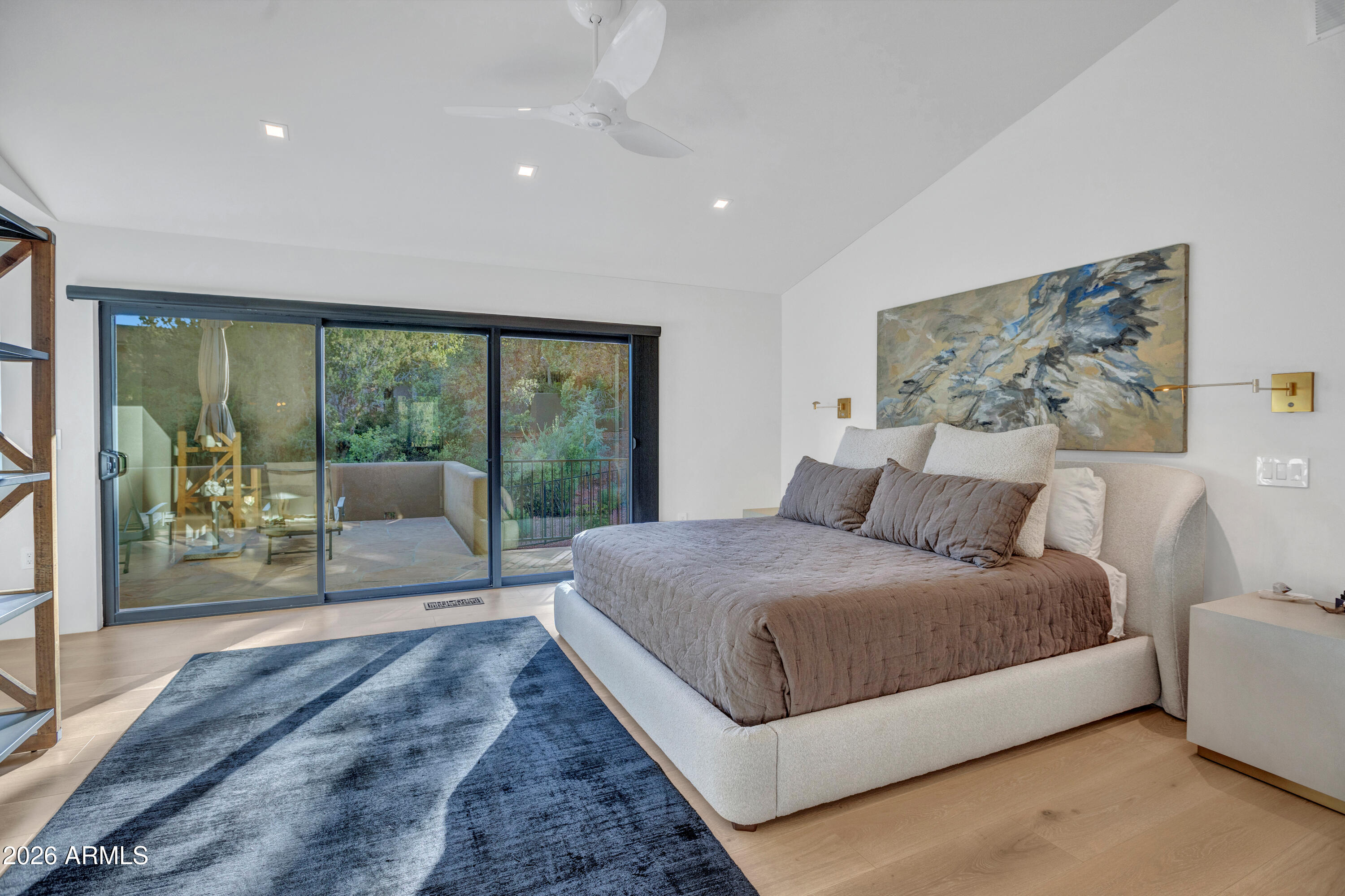 180 Rim Shadows Drive Sedona, AZ 86336 - Photo 24 of 72 a spacious bedroom with a large bed and a large window