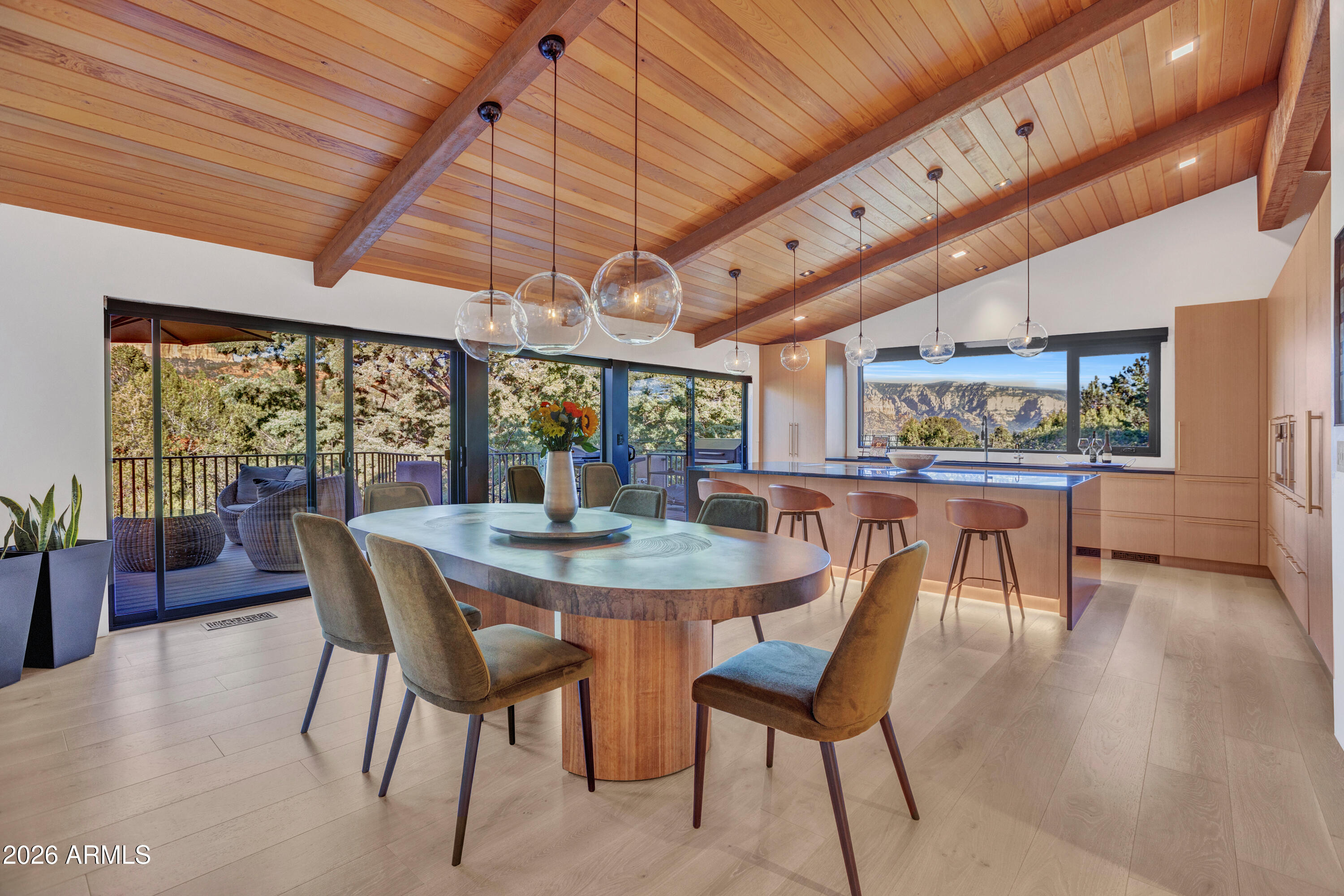180 Rim Shadows Drive Sedona, AZ 86336 - Photo 25 of 72 a view of a dining room with furniture window and wooden floor