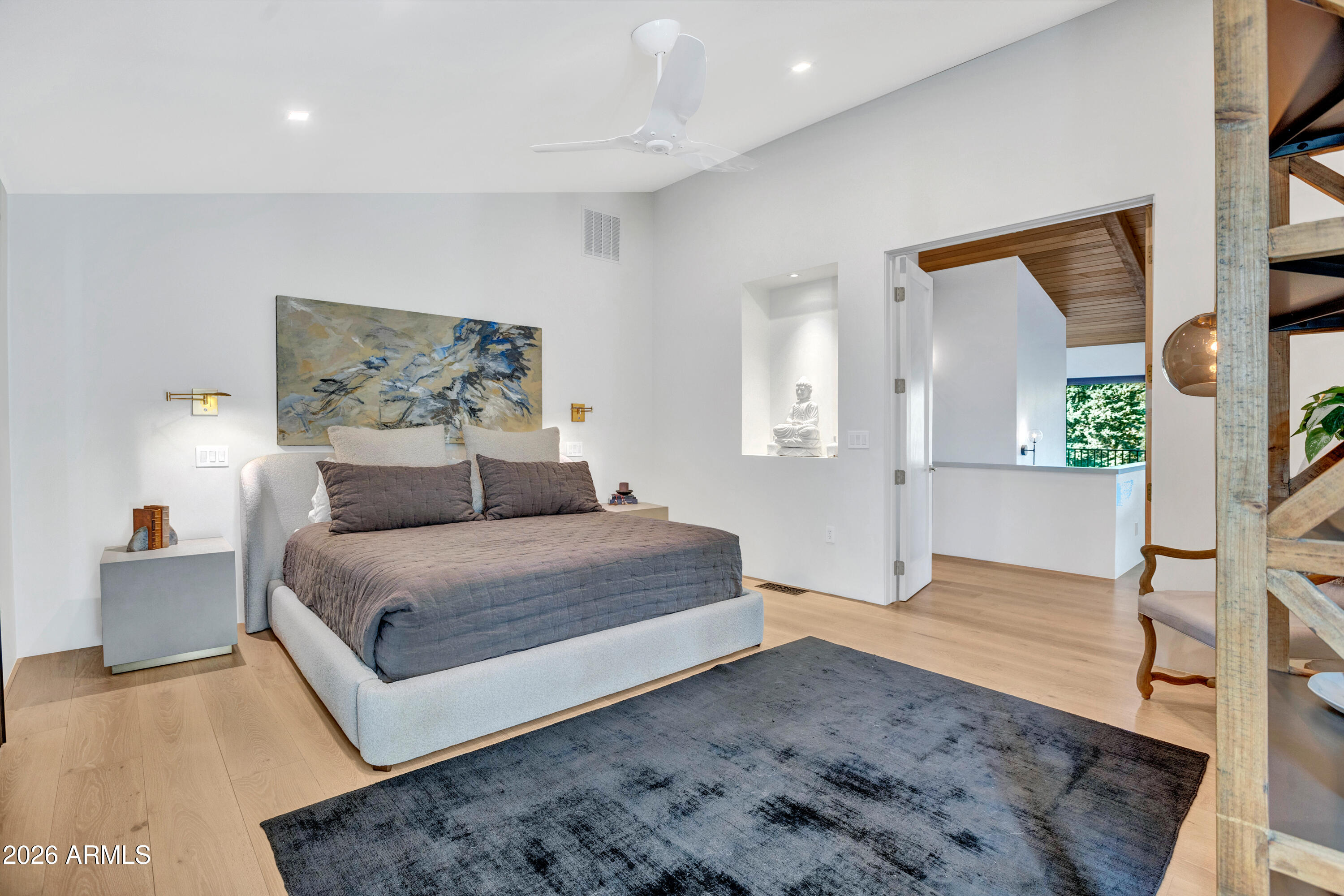 180 Rim Shadows Drive Sedona, AZ 86336 - Photo 26 of 72 a spacious bedroom with a bed and a couch