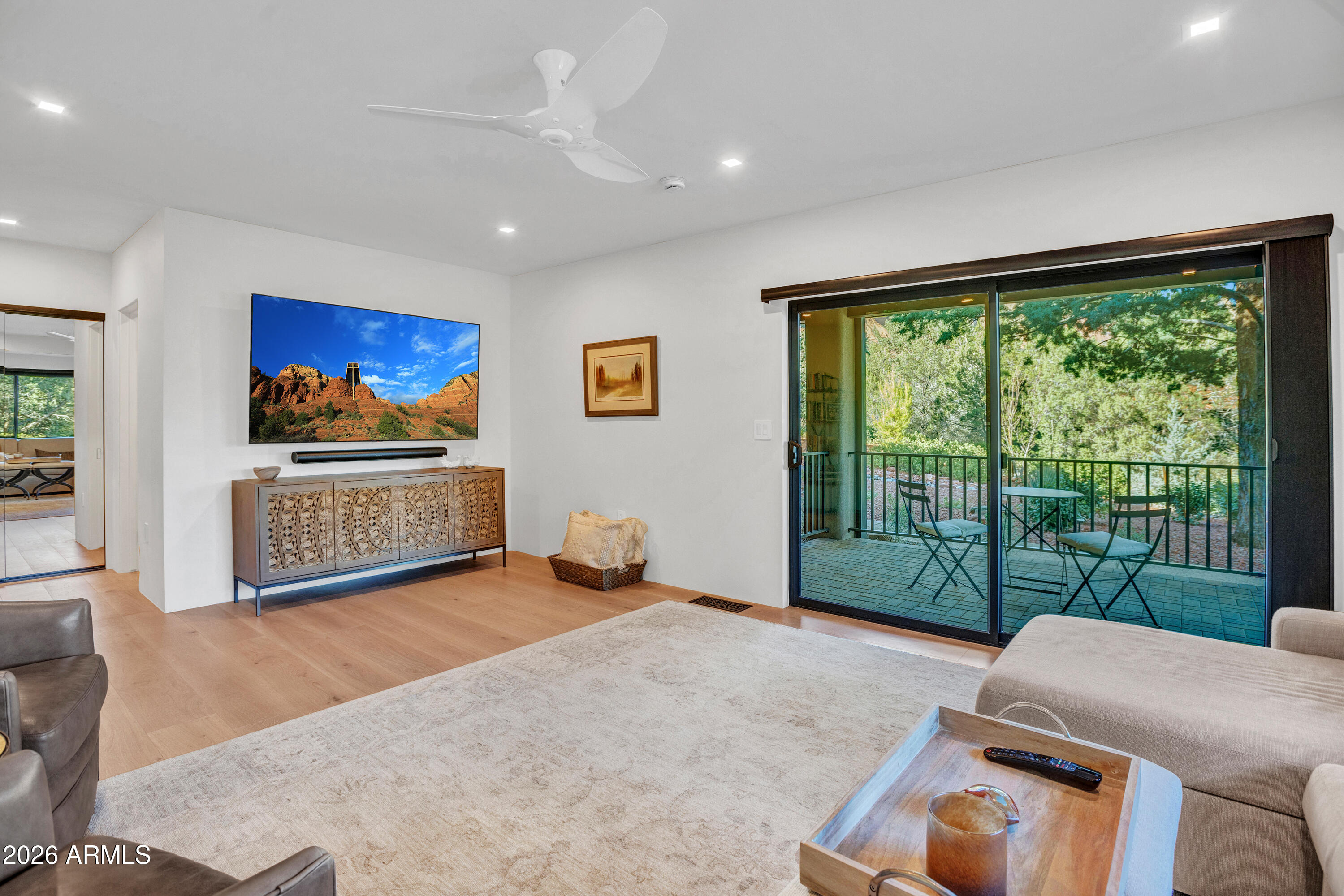 180 Rim Shadows Drive Sedona, AZ 86336 - Photo 40 of 72 a living room with furniture and a floor to ceiling window