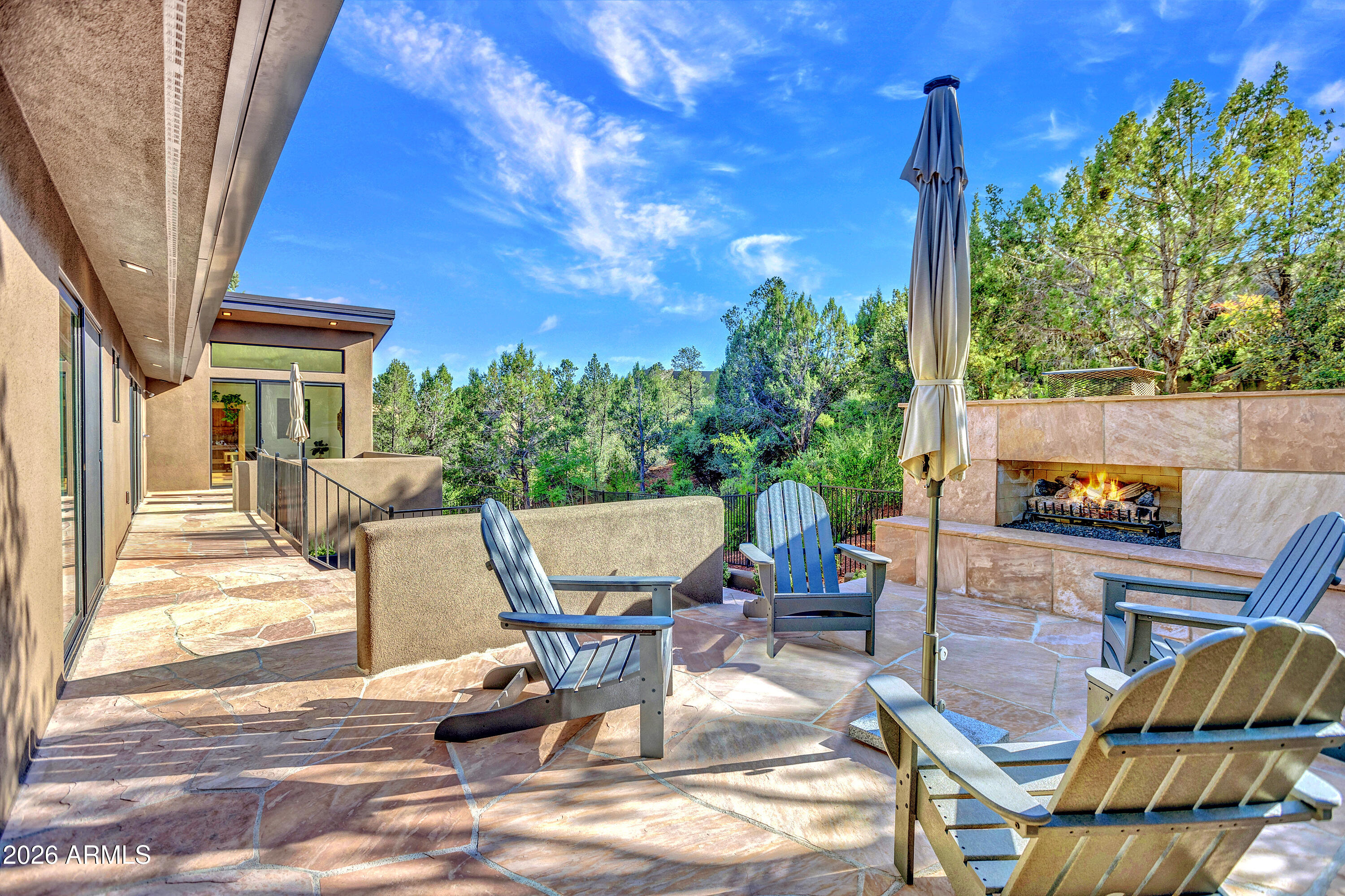 180 Rim Shadows Drive Sedona, AZ 86336 - Photo 47 of 72 a view of a patio with table and chairs and potted plants